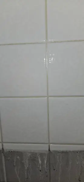 Shower tile cleaned of soot