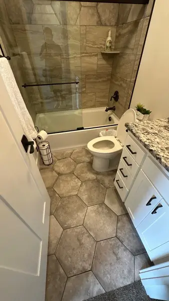 Bathroom with hexagon tile floor and tub