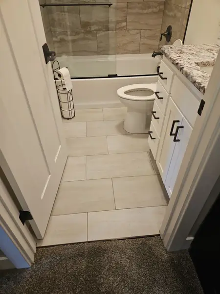 Bathroom with new tile floor and white vanity